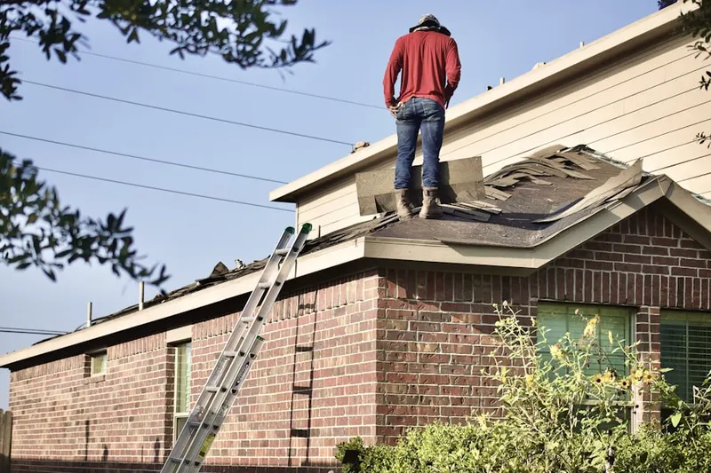 Professional roofer working on a residential roof in Orland